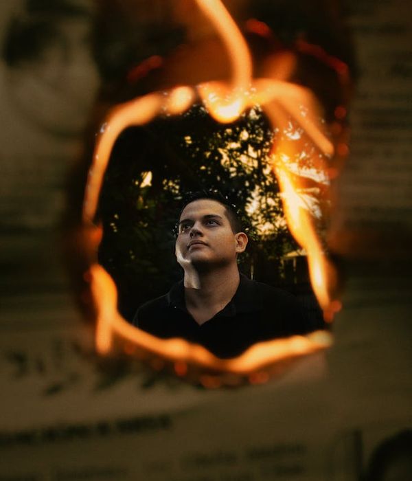 Silhouette of a man in a powerful stance against a light background.